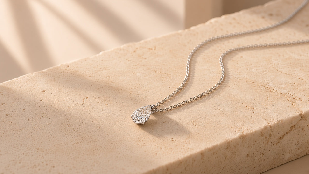 Pear-cut laboratory-grown diamond pendant on marble stone